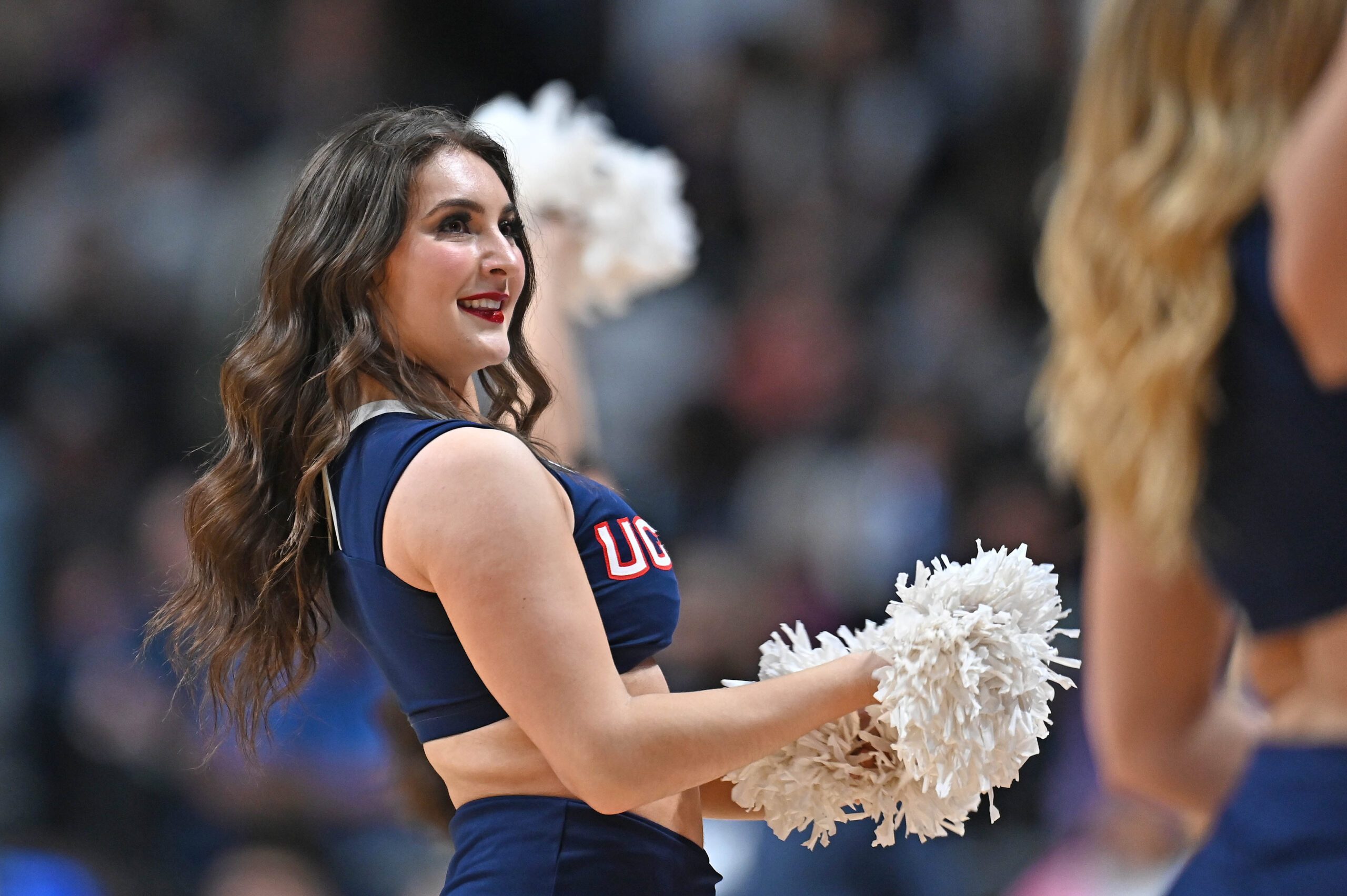 Mar 31, 2025; Spokane, WA, USA; UConn Huskies cheerleader performs against the USC Trojans during the first half of a Elite 8 NCAA Tournament basketball game at Spokane Arena. Mandatory Credit: James Snook-Imagn Images