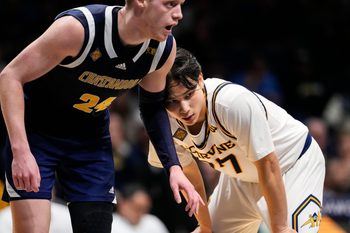 UC Irvine Anteaters guard Myles Che (77) leans against Chattanooga Mocs forward Garrison Keeslar (24) on Thursday, April 3, 2025, during the National Invitational Tournament at Hinkle Fieldhouse in Indianapolis.