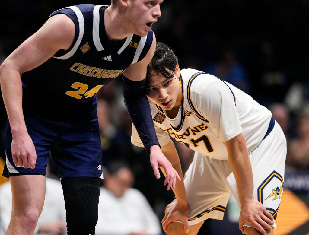 UC Irvine Anteaters guard Myles Che (77) leans against Chattanooga Mocs forward Garrison Keeslar (24) on Thursday, April 3, 2025, during the National Invitational Tournament at Hinkle Fieldhouse in Indianapolis.