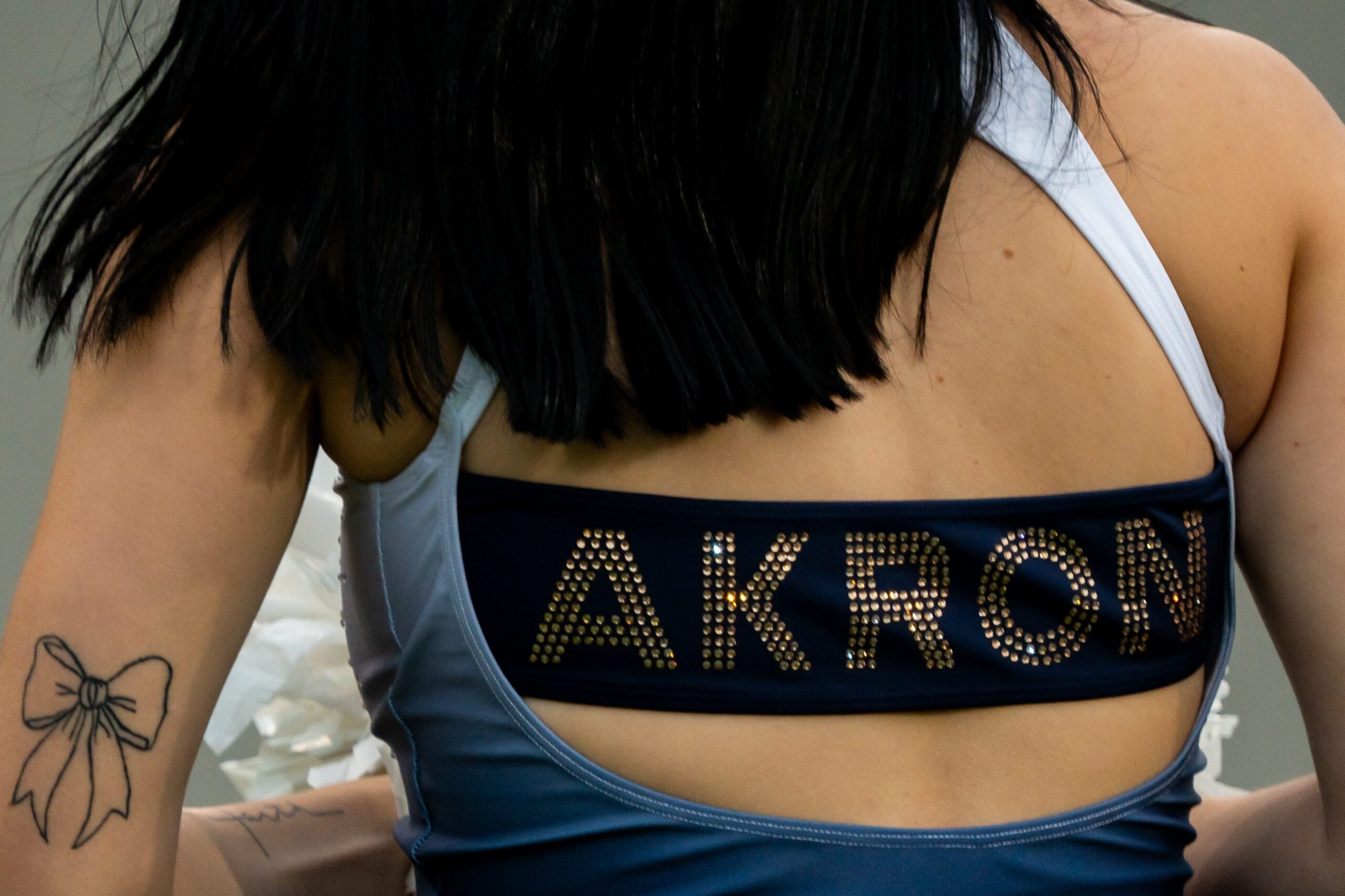 An Akron cheerleader is seen on the sidelines before the season opening football game against Wyoming, Aug. 28, 2025, at InfoCision Stadium in Akron, Ohio.