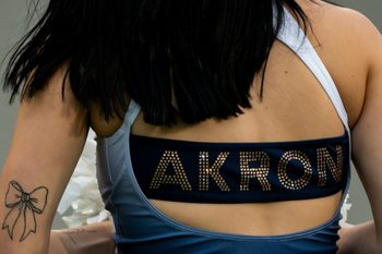 An Akron cheerleader is seen on the sidelines before the season opening football game against Wyoming, Aug. 28, 2025, at InfoCision Stadium in Akron, Ohio.
