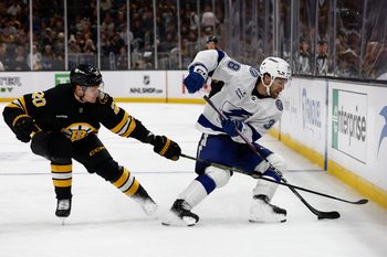 Oct 13, 2025; Boston, Massachusetts, USA; Tampa Bay Lightning left wing Brandon Hagel (38) spins away from Boston Bruins defenseman Henri Jokiharju (20) during the third period at TD Garden. Mandatory Credit: Winslow Townson-Imagn Images
