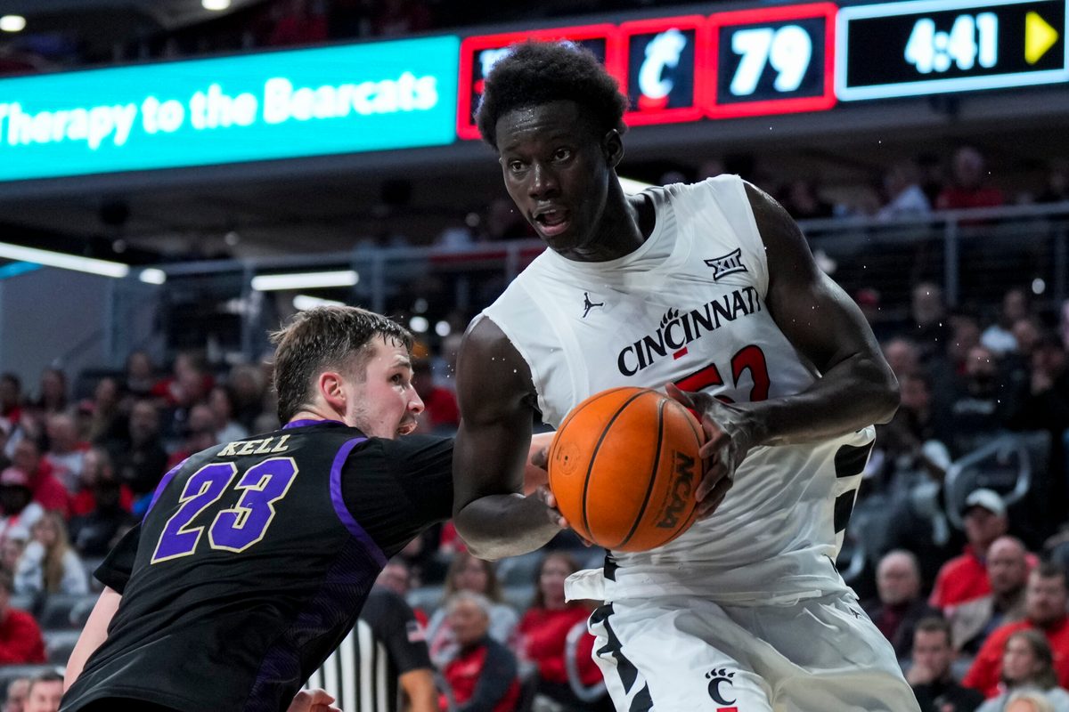 Nov 3, 2025; Cincinnati, Ohio, USA; Cincinnati Bearcats center Moustapha Thiam (52) drives to the basket against Western Carolina Catamounts forward Marcus Kell (23) in the second half at Fifth Third Arena. Mandatory Credit: Aaron Doster-Imagn Images