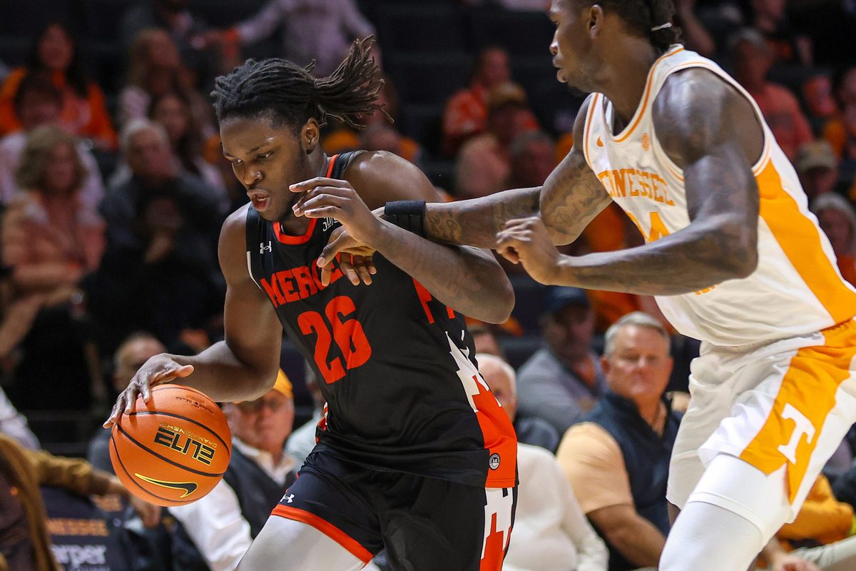 Nov 3, 2025; Knoxville, Tennessee, USA; Mercer Bears center Armani Mighty (26) moves the ball against Tennessee Volunteers center Felix Okpara (34) during the second half at Thompson-Boling Arena at Food City Center. Mandatory Credit: Randy Sartin-Imagn Images