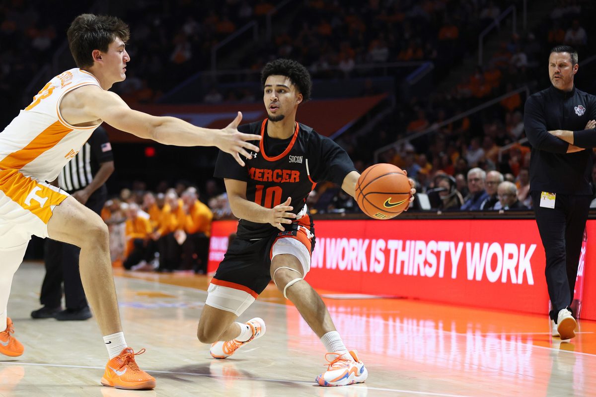 Nov 3, 2025; Knoxville, Tennessee, USA; Mercer Bears guard Tristan Gross (10) moves the ball against Tennessee Volunteers forward J.P. Estrella (13) during the second half at Thompson-Boling Arena at Food City Center. Mandatory Credit: Randy Sartin-Imagn Images