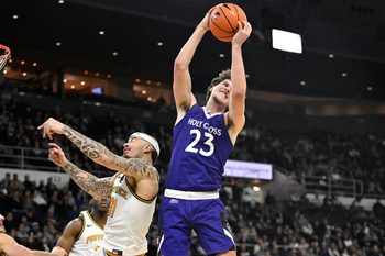 Nov 3, 2025; Providence, Rhode Island, USA; Holy Cross Crusaders forward Aidan Richard (23) beats Providence Friars forward Duncan Powell (31) to the rebound during the second half at Amica Mutual Pavilion. Mandatory Credit: Eric Canha-Imagn Images