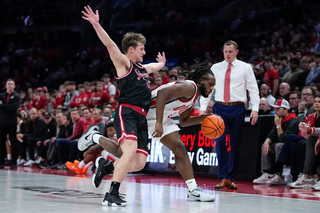 Ohio State Buckeyes guard Bruce Thornton (2) dribbles by IU Indy Jaguars guard Kyler D'Augustino (12) during the NCAA men's basketball game at Value City Arena in Columbus on Nov. 3, 2025. Ohio State won the season opener 118-102.