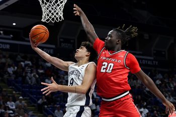 Nov 3, 2025; University Park, Pennsylvania, USA; Penn State Nittany Lions guard Melih Tunca (9) drives against Fairfield Stags forward Brandon Benjamin (20) during the first half at Bryce Jordan Center. Mandatory Credit: Matthew O'Haren-Imagn Images