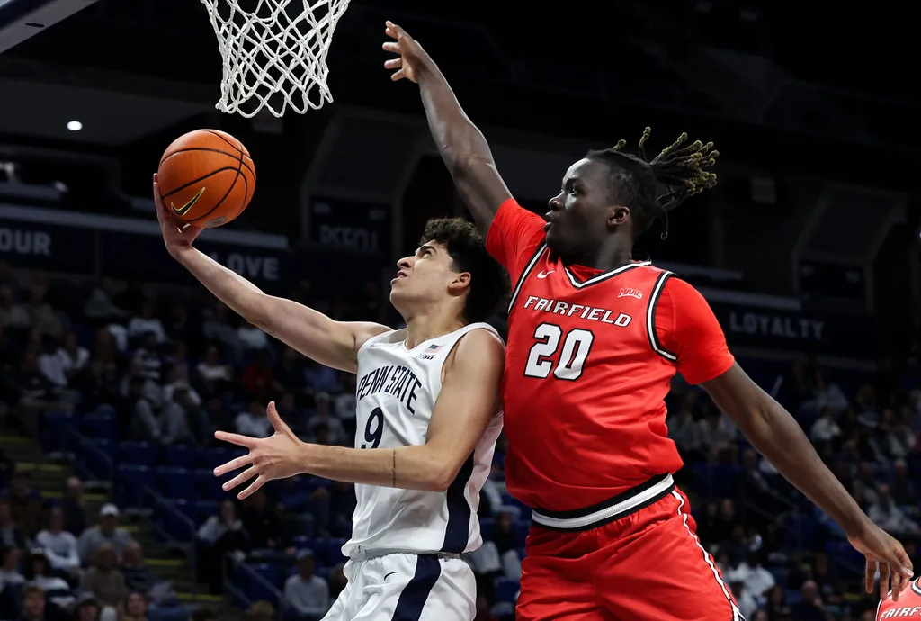 Nov 3, 2025; University Park, Pennsylvania, USA; Penn State Nittany Lions guard Melih Tunca (9) drives against Fairfield Stags forward Brandon Benjamin (20) during the first half at Bryce Jordan Center. Mandatory Credit: Matthew O'Haren-Imagn Images