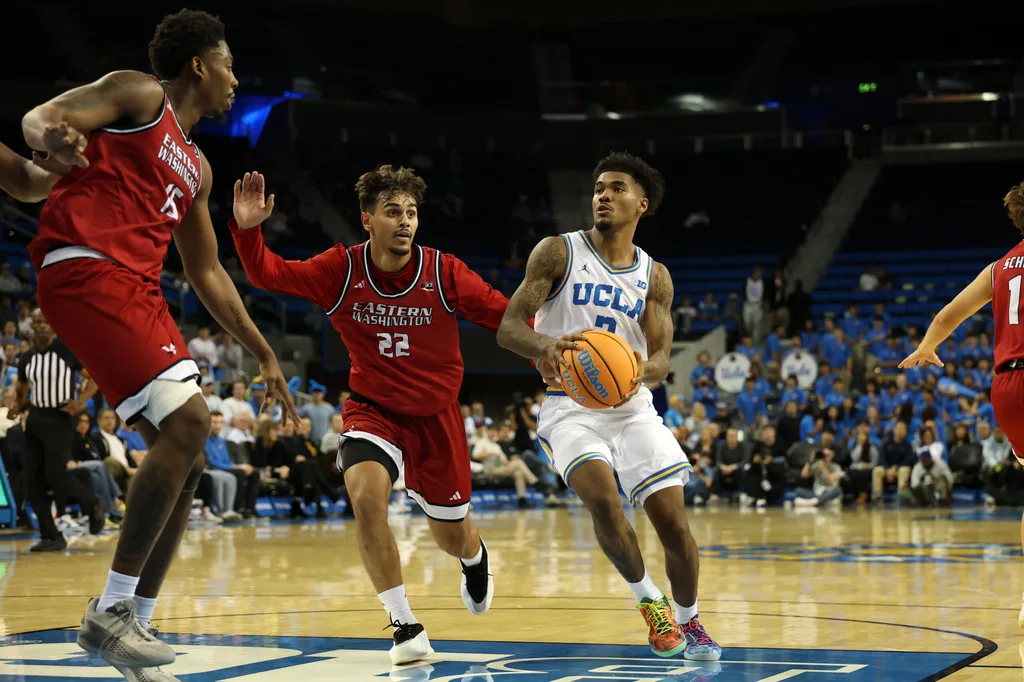 Nov 3, 2025; Los Angeles, California, USA; UCLA Bruins guard Donovan Dent (2) drives to the basket against Eastern Washington Eagles guard Jojo Anderson (22) during the second half at Pauley Pavilion presented by Wescom Financial. Mandatory Credit: Kiyoshi Mio-Imagn Images