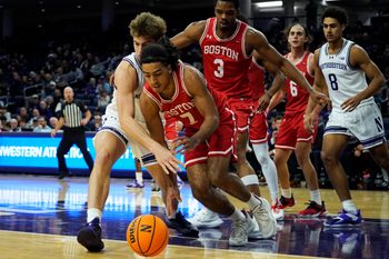 Nov 7, 2025; Evanston, Illinois, USA; Boston University Terriers guard Azmar Abdullah (7) and Northwestern Wildcats forward Tyler Kropp (1) go for a loose ball during the first half at Welsh-Ryan Arena. Mandatory Credit: David Banks-Imagn Images