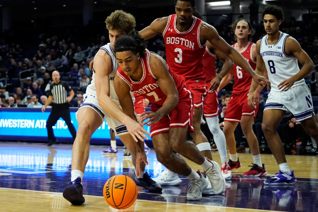 Nov 7, 2025; Evanston, Illinois, USA; Boston University Terriers guard Azmar Abdullah (7) and Northwestern Wildcats forward Tyler Kropp (1) go for a loose ball during the first half at Welsh-Ryan Arena. Mandatory Credit: David Banks-Imagn Images