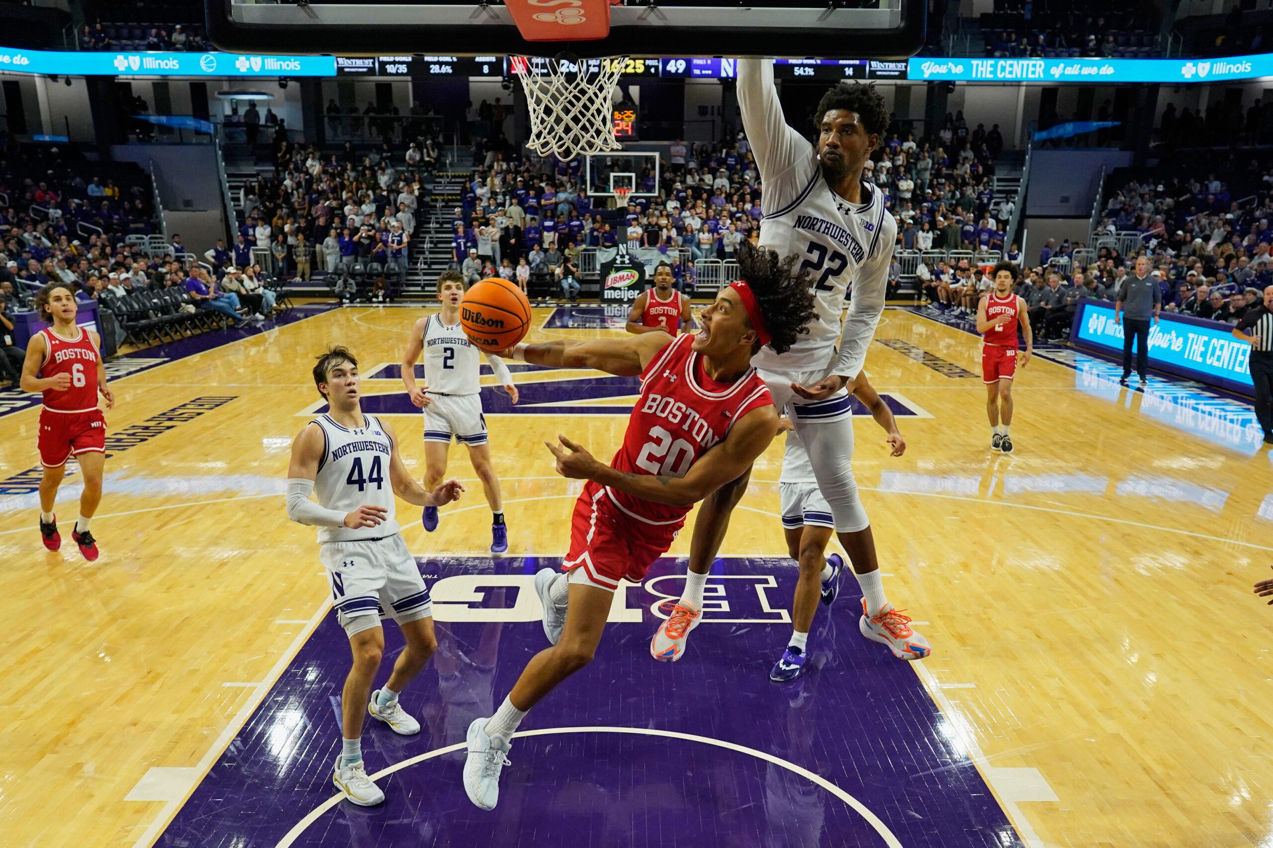 Nov 7, 2025; Evanston, Illinois, USA; Boston University Terriers guard Michael McNair (20) shoots the ball against Northwestern Wildcats forward Arrinten Page (22) during the second half at Welsh-Ryan Arena. Mandatory Credit: David Banks-Imagn Images