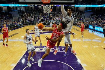 Nov 7, 2025; Evanston, Illinois, USA; Boston University Terriers guard Michael McNair (20) shoots the ball against Northwestern Wildcats forward Arrinten Page (22) during the second half at Welsh-Ryan Arena. Mandatory Credit: David Banks-Imagn Images