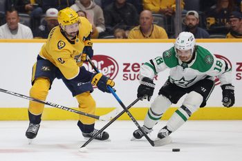 Nov 8, 2025; Nashville, Tennessee, USA; Nashville Predators left wing Filip Forsberg (9) moves the puck as Dallas Stars center Sam Steel (18) defends during the third period at Bridgestone Arena. Mandatory Credit: Alan Poizner-Imagn Images