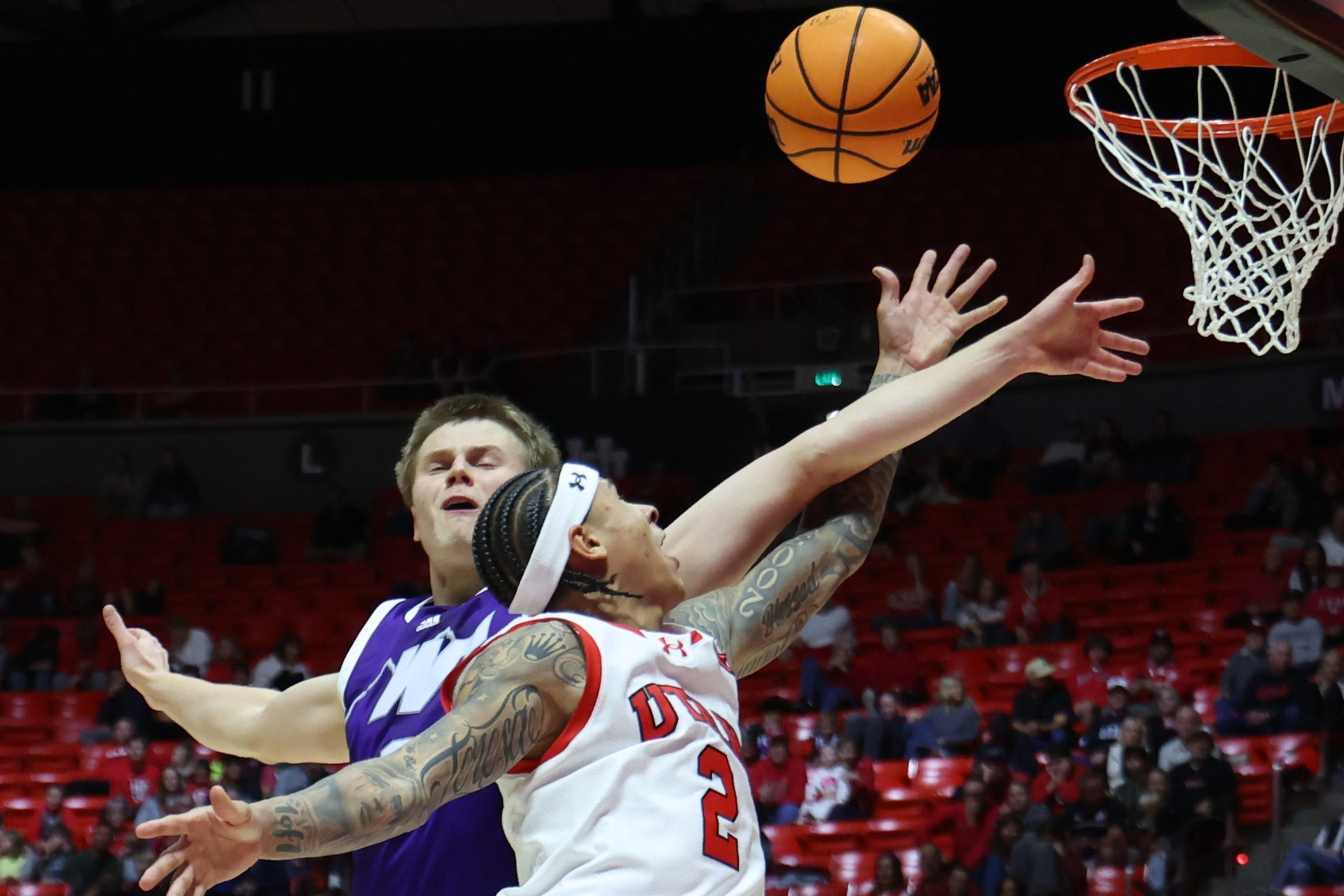 Nov 8, 2025; Salt Lake City, Utah, USA; Utah Utes guard Terrence Brown (2) goes to the basket against Weber State Wildcats forward Viljami Vartiainen (8) during the second half at Jon M. Huntsman Center. Mandatory Credit: Rob Gray-Imagn Images