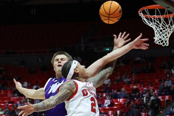 Nov 8, 2025; Salt Lake City, Utah, USA; Utah Utes guard Terrence Brown (2) goes to the basket against Weber State Wildcats forward Viljami Vartiainen (8) during the second half at Jon M. Huntsman Center. Mandatory Credit: Rob Gray-Imagn Images