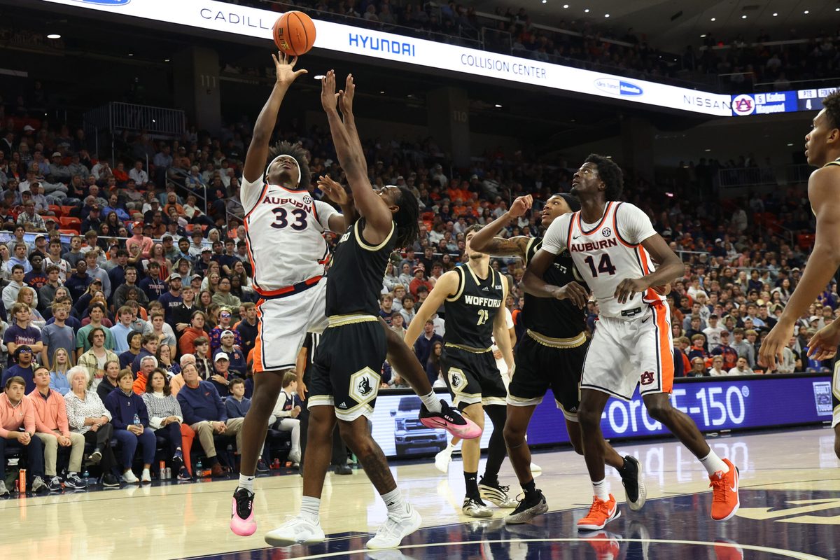 Nov 11, 2025; Auburn, Alabama, USA; Wofford Terriers guard Kahmare Holmes (11) tries to block the shot of Auburn Tigers forward Sebastian Williams-Adams (33) during the second half at Neville Arena. Mandatory Credit: John Reed-Imagn Images