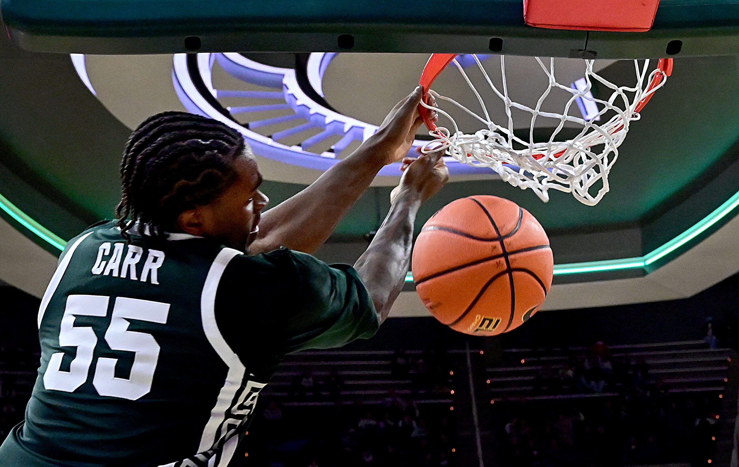 Nov 13, 2025; East Lansing, Michigan, USA;  Michigan State Spartans forward Coen Carr (55) watches a second half dunk go through the net against the San Jose State Spartans at Jack Breslin Student Events Center. Mandatory Credit: Dale Young-Imagn Images