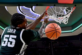 Nov 13, 2025; East Lansing, Michigan, USA;  Michigan State Spartans forward Coen Carr (55) watches a second half dunk go through the net against the San Jose State Spartans at Jack Breslin Student Events Center. Mandatory Credit: Dale Young-Imagn Images