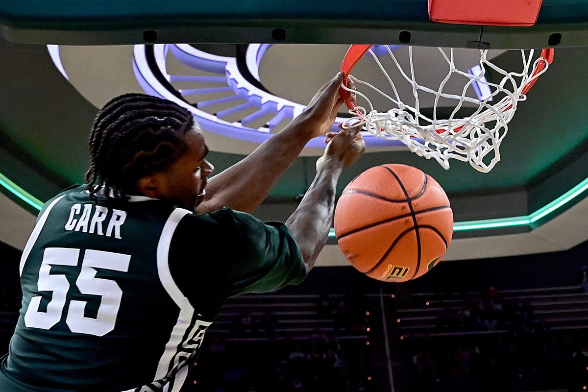 Nov 13, 2025; East Lansing, Michigan, USA; Michigan State Spartans forward Coen Carr (55) watches a second half dunk go through the net against the San Jose State Spartans at Jack Breslin Student Events Center. Mandatory Credit: Dale Young-Imagn Images