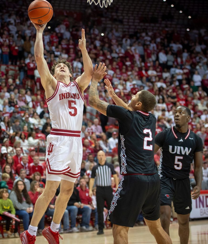 Indiana's Conor Enright (5) shoots over Incarnate Word's Tahj Staveskie (2) and Davion Bailey (5) during the Indiana versus Incarnate Word men's basketball game at Simon Skjodt Assembly Hall on Sunday, Nov. 16, 2025.