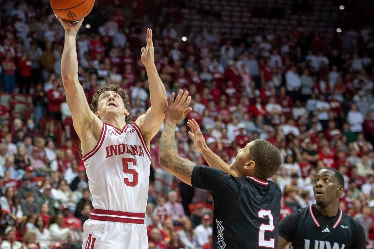 Indiana's Conor Enright (5) shoots over Incarnate Word's Tahj Staveskie (2) and Davion Bailey (5) during the Indiana versus Incarnate Word men's basketball game at Simon Skjodt Assembly Hall on Sunday, Nov. 16, 2025.