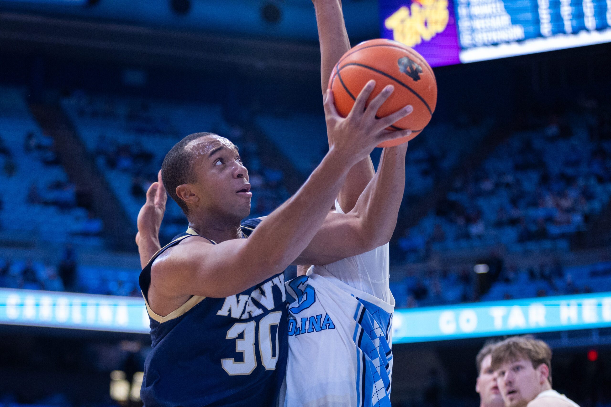 Nov 18, 2025; Chapel Hill, North Carolina, USA; Navy Midshipmen forward Mike Woods (30) shoots on North Carolina Tar Heels forward Jarin Stevenson (15) during the first half at Dean E. Smith Center. Mandatory Credit: Scott Kinser-Imagn Images
