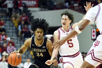 Nov 20, 2025; Bloomington, Indiana, USA; Lindenwood Lions guard Clayton Jackson (34) drives to the basket against Indiana Hoosiers guard Conor Enright (5) during the second half at Simon Skjodt Assembly Hall. Mandatory Credit: Robert Goddin-Imagn Images