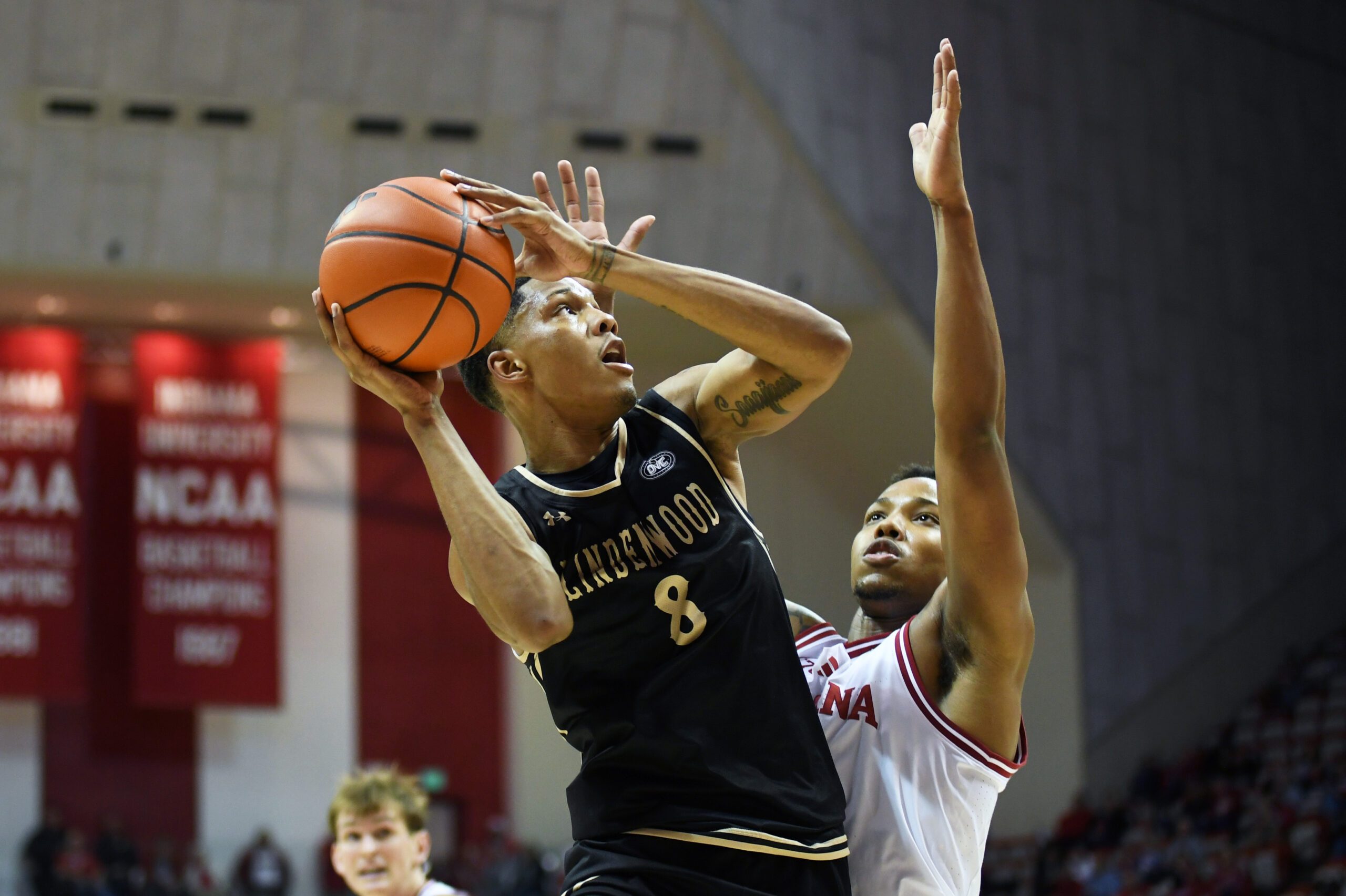 Nov 20, 2025; Bloomington, Indiana, USA; Lindenwood Lions guard Anias Futrell (8) shoots the ball against Indiana Hoosiers forward Nick Dorn (7) during the second half at Simon Skjodt Assembly Hall. Mandatory Credit: Robert Goddin-Imagn Images