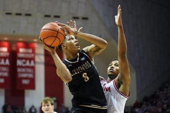 Nov 20, 2025; Bloomington, Indiana, USA; Lindenwood Lions guard Anias Futrell (8) shoots the ball against Indiana Hoosiers forward Nick Dorn (7) during the second half at Simon Skjodt Assembly Hall. Mandatory Credit: Robert Goddin-Imagn Images
