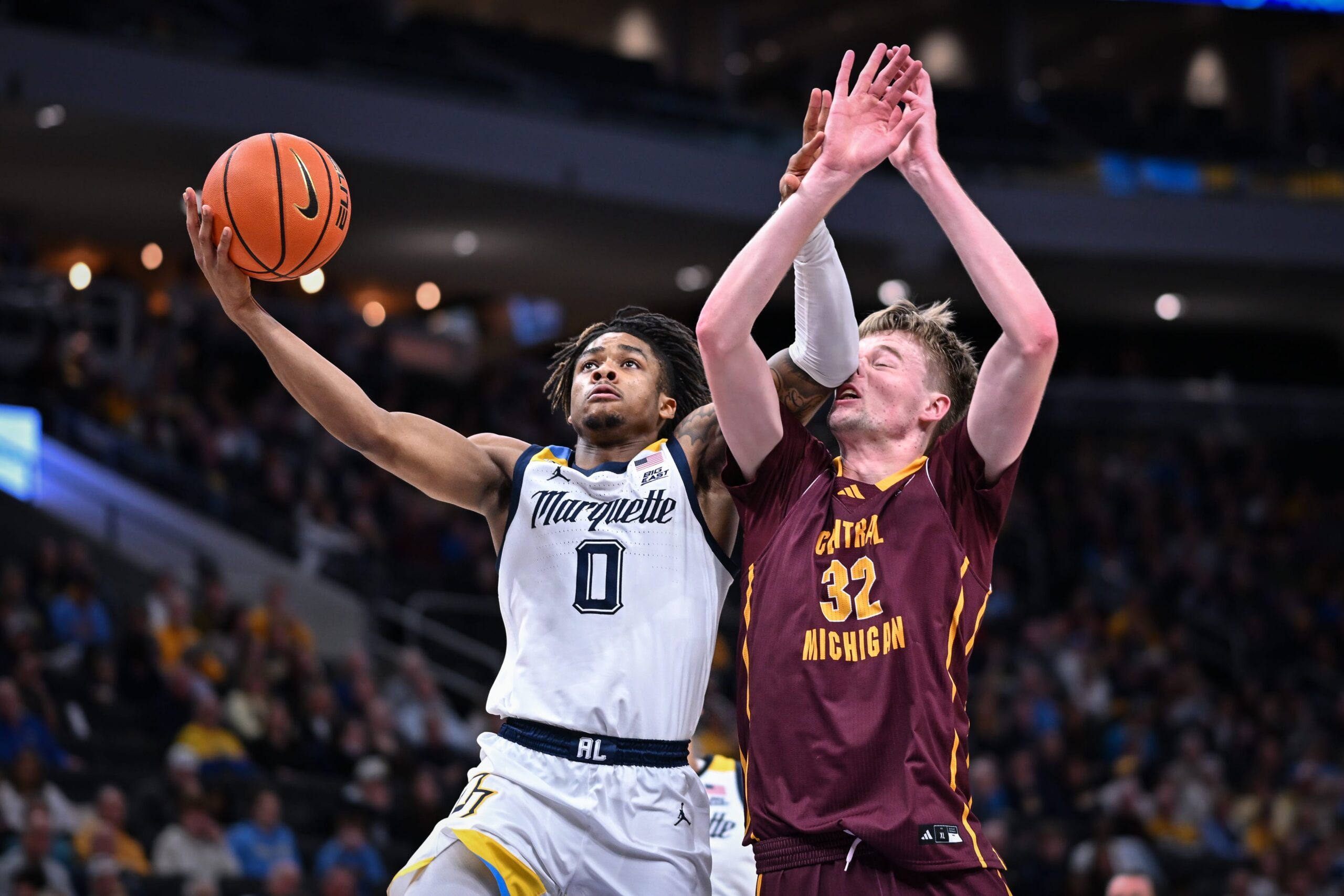 Marquette guard Nigel James Jr. (0) goes to the basket against Central Michigan center Nathan Claerbaut (32) in the first half of a game Saturday, November 22, 2025, at Fiserv Forum in Milwaukee, Wisconsin.
