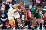 Louisville Cardinals guard Adrian Wooley (14) steals the ball from Eastern Michigan Eagles guard Carlos Hart (2) in the second half. The Cards beat the Eagles 87-46 Monday night, Nov. 24, 2025 at the KFC Yum! Center in Louisville, Kentucky.