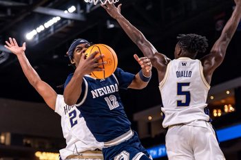 Nevada Wolf Pack guard Tayshawn Comer (12) is fouled as he goes up for a shot during the first half of their game in the Acrisure Series in Palm Desert, Calif., Thursday, Nov. 27, 2025.
