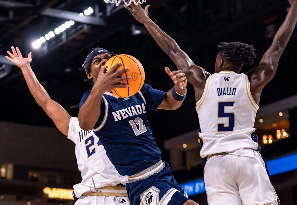 Nevada Wolf Pack guard Tayshawn Comer (12) is fouled as he goes up for a shot during the first half of their game in the Acrisure Series in Palm Desert, Calif., Thursday, Nov. 27, 2025.