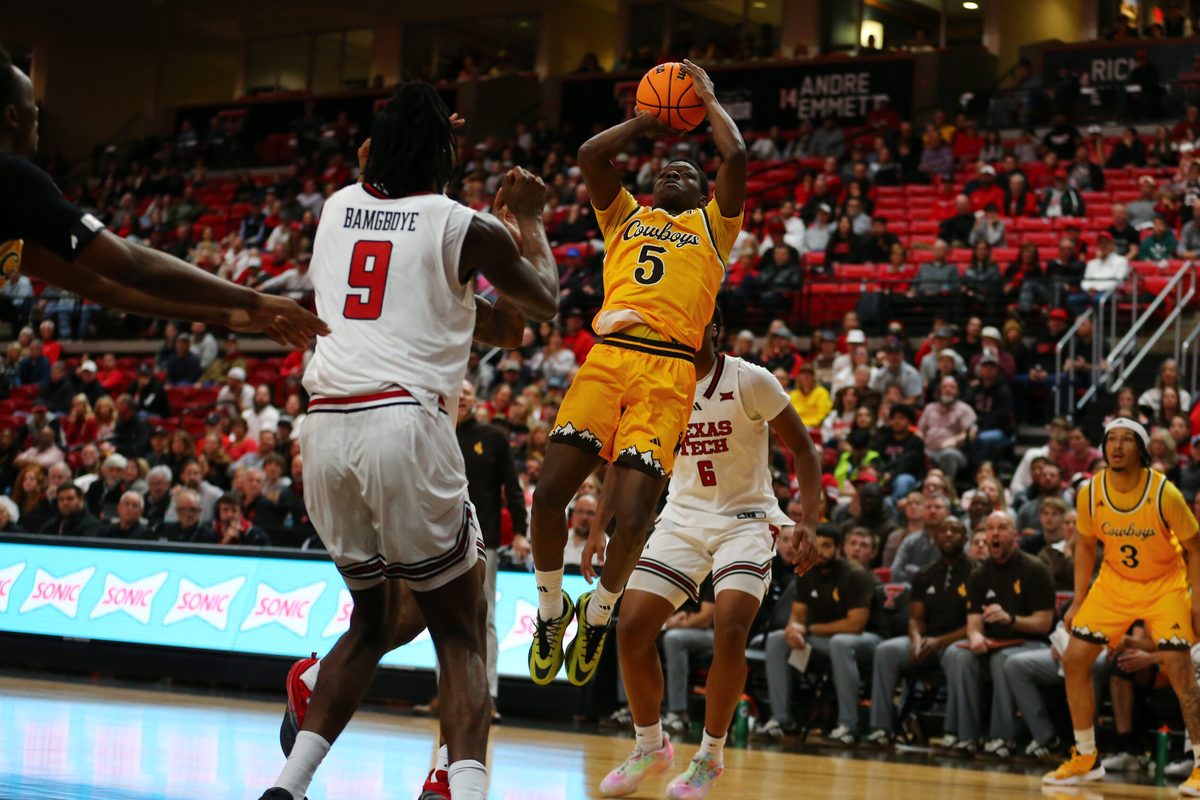 Nov 30, 2025; Lubbock, Texas, USA;  Wyoming Cowboys guard Leland Walker (5) shoots a fadeaway shot against Texas Tech Red Raiders forward Luke Bamgboye (9) in the second half at United Supermarkets Arena. Mandatory Credit: Michael C. Johnson-Imagn Images