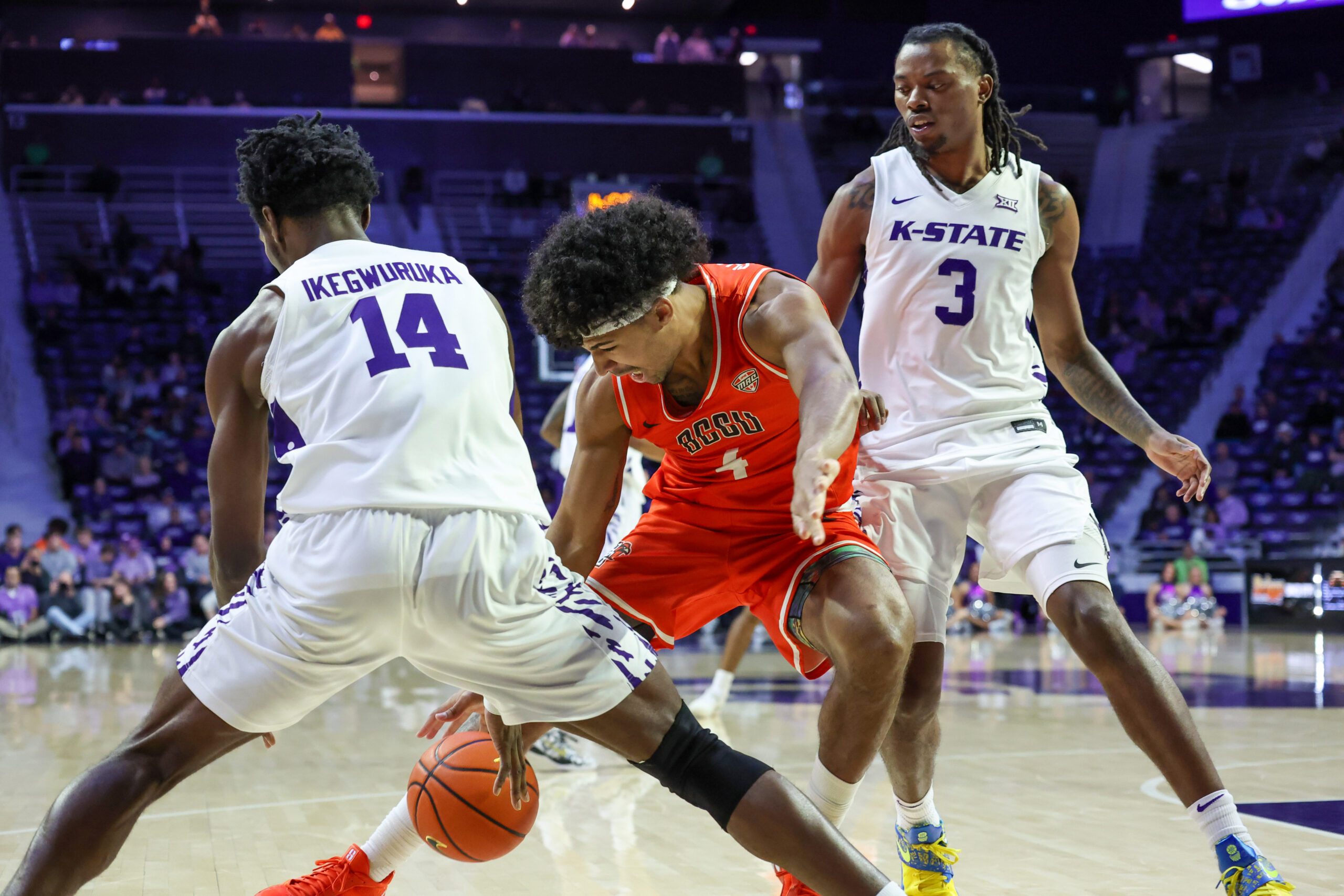 Dec 1, 2025; Manhattan, Kansas, USA; Bowling Green Falcons guard Josiah Shackelford (4) and Kansas State Wildcats guards Mobi Ikegwuruka (14) and C.J. Jones (3) go after a loose ball during the second half at Bramlage Coliseum. Mandatory Credit: Scott Sewell-Imagn Images