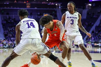 Dec 1, 2025; Manhattan, Kansas, USA; Bowling Green Falcons guard Josiah Shackelford (4) and Kansas State Wildcats guards Mobi Ikegwuruka (14) and C.J. Jones (3) go after a loose ball during the second half at Bramlage Coliseum. Mandatory Credit: Scott Sewell-Imagn Images