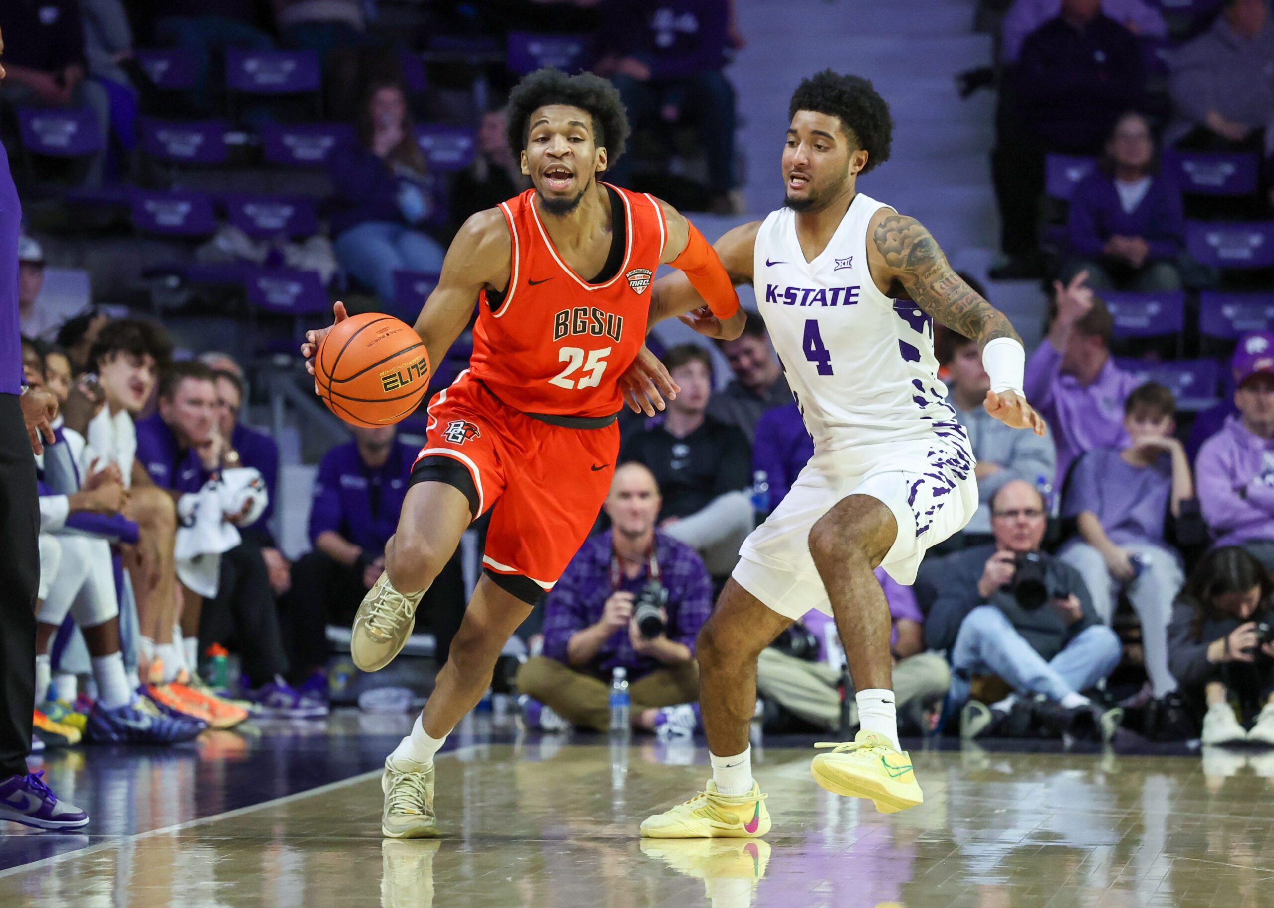 Dec 1, 2025; Manhattan, Kansas, USA; Bowling Green Falcons guard Justin Thomas (25) brings the ball up court against Kansas State Wildcats guard P.J. Haggerty (4) during the second half at Bramlage Coliseum. Mandatory Credit: Scott Sewell-Imagn Images