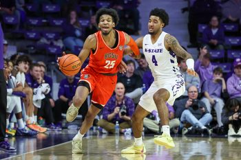 Dec 1, 2025; Manhattan, Kansas, USA; Bowling Green Falcons guard Justin Thomas (25) brings the ball up court against Kansas State Wildcats guard P.J. Haggerty (4) during the second half at Bramlage Coliseum. Mandatory Credit: Scott Sewell-Imagn Images