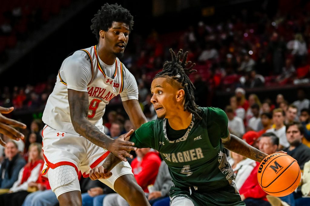 Dec 2, 2025; College Park, Maryland, USA; Wagner Seahawks guard John Awoke (4) makes a move to the basket on Maryland Terrapins forward Solomon Washington (9) during the first half at Xfinity Center. Mandatory Credit: Tommy Gilligan-Imagn Images