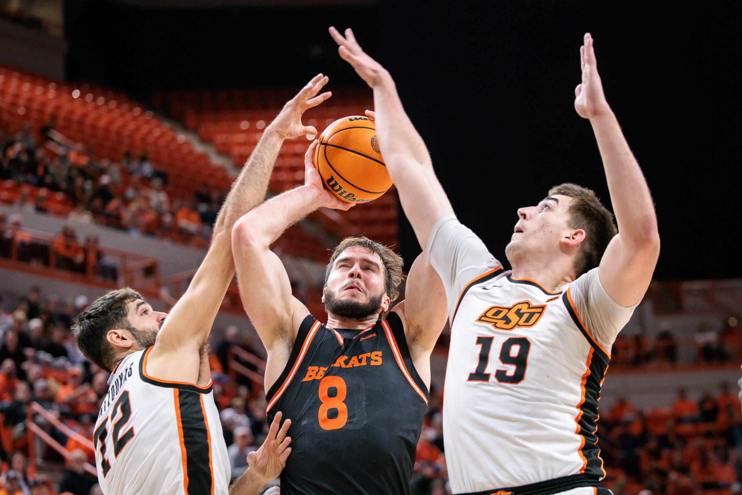 Dec 2, 2025; Stillwater, Oklahoma, USA; Sam Houston Bearkats forward Veljko Ilic (8) shoots the ball around Oklahoma State Cowboys forward Lefteris Mantzoukas (72) and Oklahoma State Cowboys forward Andrija Vukovic (19) during the second half at Gallagher-Iba Arena. Mandatory Credit: William Purnell-Imagn Images
