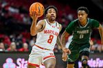 Dec 2, 2025; College Park, Maryland, USA;  Maryland Terrapins guard David Coit (8) makes a move to the basket on Wagner Seahawks guard Nick Jones (0) during the second half at Xfinity Center. Mandatory Credit: Tommy Gilligan-Imagn Images