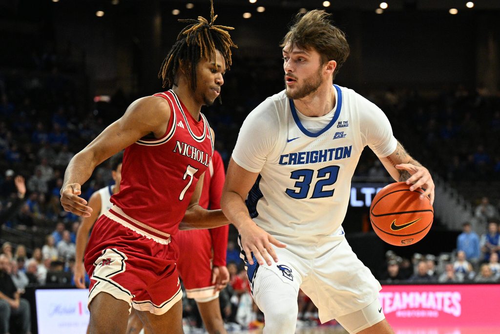 Dec 2, 2025; Omaha, Nebraska, USA; Creighton Bluejays forward Owen Freeman (32) dribbles against Nicholls State Colonels forward Grant Sanders (7) during the second half at CHI Health Center Omaha. Mandatory Credit: Steven Branscombe-Imagn Images