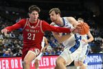 Dec 2, 2025; Omaha, Nebraska, USA;  Creighton Bluejays forward Isaac Traudt (41) drives against Nicholls State Colonels guard Nick Krass (21) during the second half at CHI Health Center Omaha. Mandatory Credit: Steven Branscombe-Imagn Images