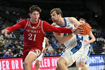 Dec 2, 2025; Omaha, Nebraska, USA;  Creighton Bluejays forward Isaac Traudt (41) drives against Nicholls State Colonels guard Nick Krass (21) during the second half at CHI Health Center Omaha. Mandatory Credit: Steven Branscombe-Imagn Images