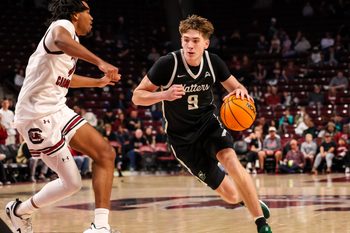 Dec 6, 2025; Columbia, South Carolina, USA; Stetson Hatters forward Collin Kuhl (9) drives past South Carolina Gamecocks guard Kobe Knox (4) in the second half at Colonial Life Arena. Mandatory Credit: Jeff Blake-Imagn Images