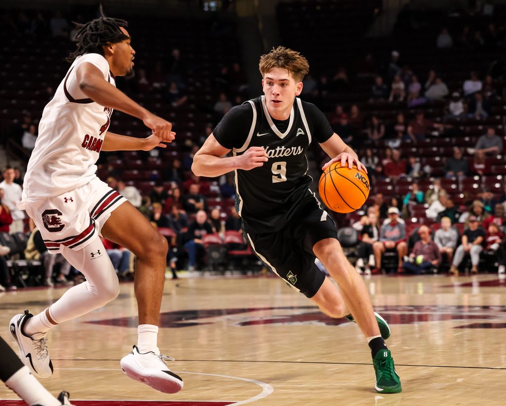 Dec 6, 2025; Columbia, South Carolina, USA; Stetson Hatters forward Collin Kuhl (9) drives past South Carolina Gamecocks guard Kobe Knox (4) in the second half at Colonial Life Arena. Mandatory Credit: Jeff Blake-Imagn Images