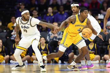 Dec 6, 2025; Philadelphia, PA, USA; La Salle Explorers guard Rob Dockery (99) grabs the wrist of Drexel Dragons guard Shane Blakeney (4) during the second half at Xfinity Mobile Arena. Mandatory Credit: Bill Streicher-Imagn Images