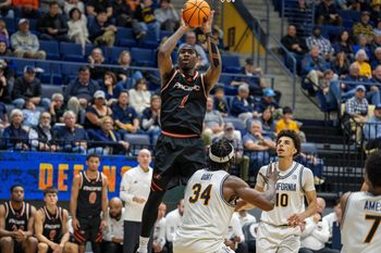 Dec 6, 2025; Berkeley, California, USA; Pacific Tigers guard Justin Rochelin (1) shoots the basketball over California Golden Bears forward Lee Dort (34) during the second half at Haas Pavilion. Mandatory Credit: Neville E. Guard-Imagn Images